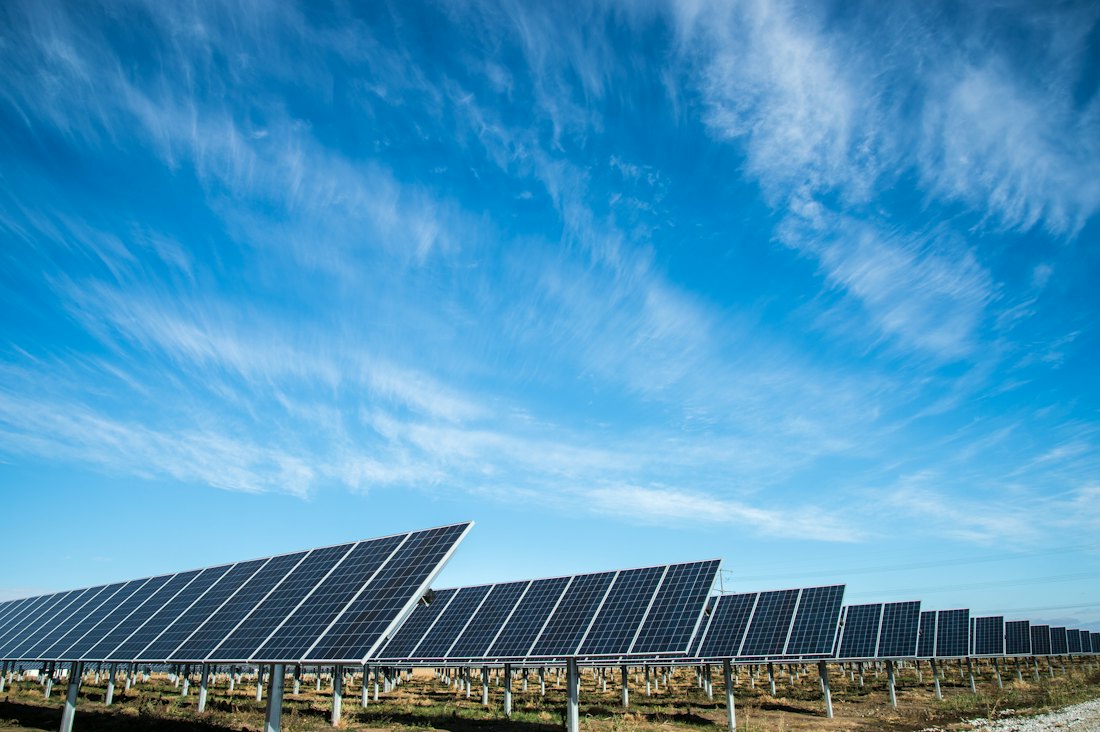 Ground-mounted solar PV array feeding an industrial supply